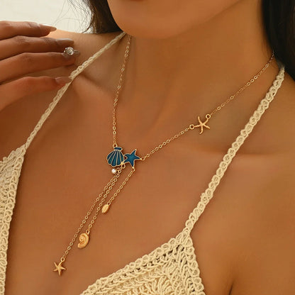 Collier Élégant en Or avec Étoile et Coquillage Bleu