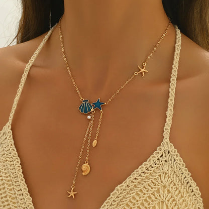 Collier Élégant en Or avec Étoile et Coquillage Bleu